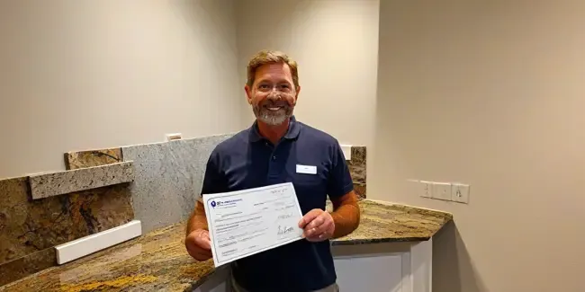 Granite Countertop Installation professional holding an estimate