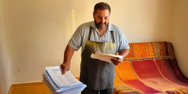 Rug Cleaning professional holding a work order